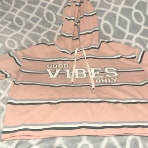 A pink shirt with grayish,green,and white strips.